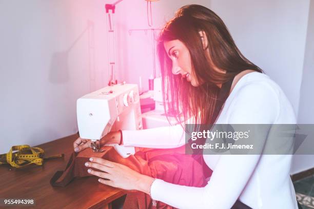 woman seamstress sewing machine in the workshop - costura stock pictures, royalty-free photos & images