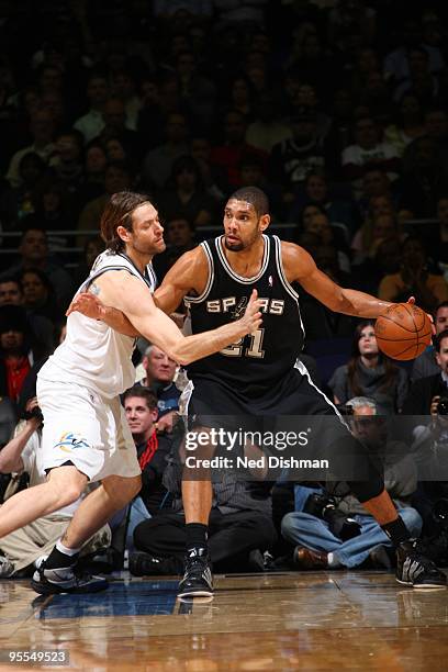 Tim Duncan of the San Antonio Spurs backs up against Fabricio Oberto of the Washington Wizards at the Verizon Center on January 2, 2010 in...