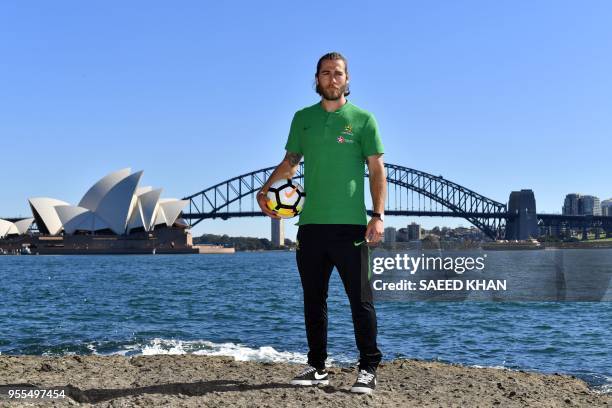 Australian national football team member Josh Brillante poses during a photo session in front of the Opera House and Harbour Bridge, Sydney's iconic...