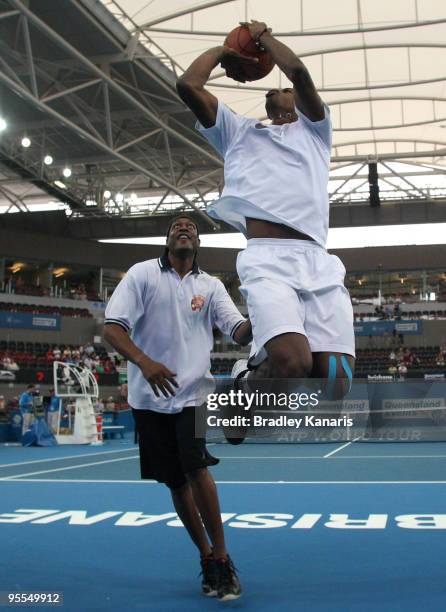 Gael Monfrils of France plays a social game of basketball with former baskeball player Leroy Loggins during day one of the Brisbane International...