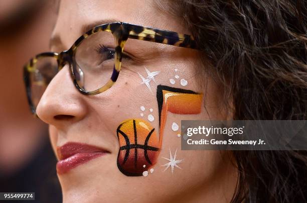 Fan has the logo of the Utah Jazz painted on her face watching Game Four of Round Two of the 2018 NBA Playoffs as the Houston Rockets played the Utah...