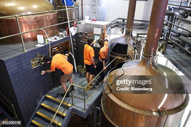 Employees work in the malt milling room of The Malt Shovel Brewery, operated by Lion Pty Ltd., in Sydney, Australia, on Thursday, April 19, 2018....