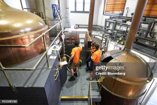 Employees work in the malt milling room of The Malt Shovel Brewery, operated by Lion Pty Ltd., in Sydney, Australia, on Thursday, April 19, 2018....