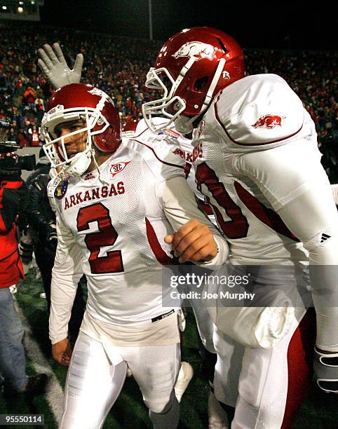 Alex Tejada of the Arkansas Razorbacks is congratulated by his teammates after kicking the winning field goal against the East Carolina Pirates...