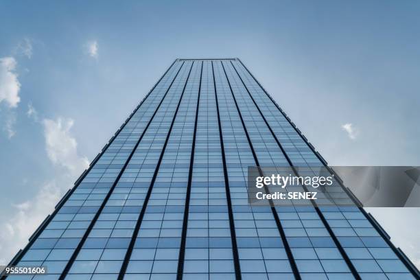 low angle view of skyscrapers - wolkenkrabber stockfoto's en -beelden