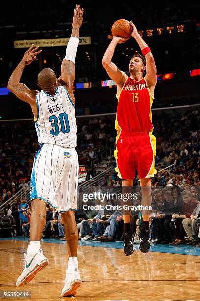 Joey Dorsey of the Houston Rockets makes a shot over David West of the New Orleans Hornets at the New Orleans Arena on January 2, 2010 in New...