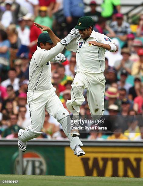 Umur Gul of Pakistan celebrates with Kamran Akmal of Pakistan after catching Ricky Ponting of Australia for a duck during day one of the Second Test...