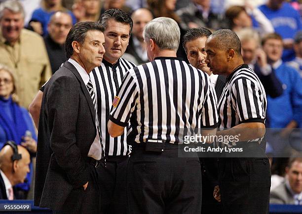 Rick Pitino the Head coach of the Louisville Cardinals and John Calipari the Head Coach of the Kentucky Wildcats talk with the game officals during...