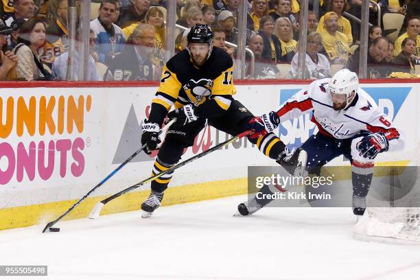 Bryan Rust of the Pittsburgh Penguins and Michal Kempny of the Washington Capitals battle for control of the puck in Game Four of the Eastern...