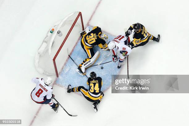 Derick Brassard of the Pittsburgh Penguins and Tom Kuhnhackl combine to help Matt Murray stop a shot from Brett Connolly of the Washington Capitals...