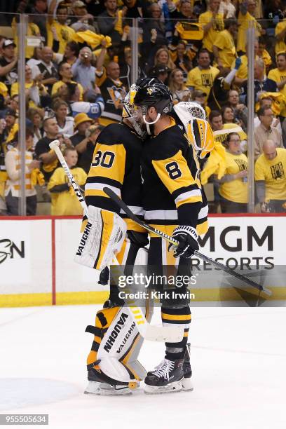 Brian Dumoulin of the Pittsburgh Penguins congratulates Matt Murray after defeating the Washington Capitals 3-1 in Game Four of the Eastern...