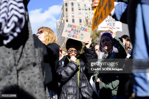 Girl holds up a placard reading "Immigrants Make America Great" at a "Love Rally" in Washington Square Park organised in response to Donald Trump's...