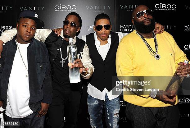 Guest, Fashion designer/recording artist Sean "Diddy" Combs, recording artist Nelly and recording artist Rick Ross attend the grand opening of the...