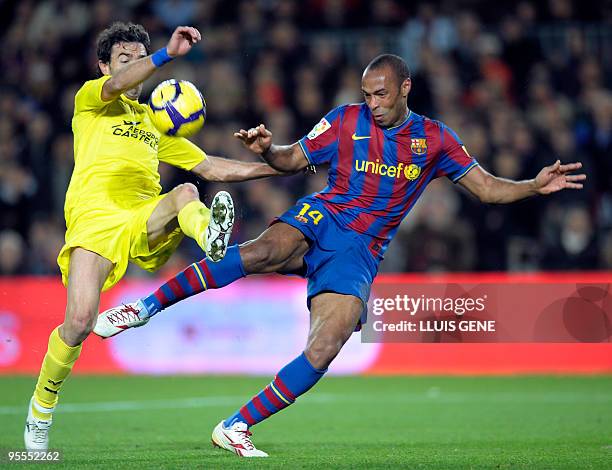 Barcelona's French forward Thierry Henry vies with Villarreal's defender Javi Venta during their Spanish League football match between Barcelona and...