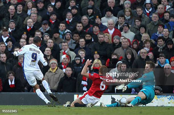 Tomasz Kuszczak and Wes Brown of Manchester United are unable to stop Jermaine Beckford of Leeds United scoring the opening goal during the FA Cup...
