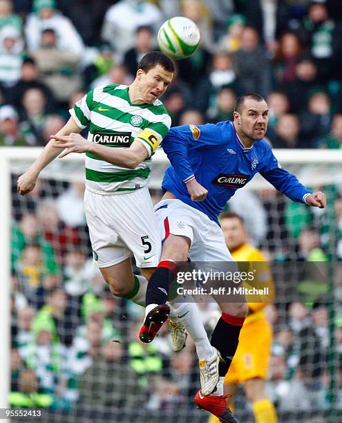 Gary Caldwell of Celtic tackles Kris Boyd of Rangers during the Scottish Premier League match between Celtic and Rangers at Celtic Park on January 3,...