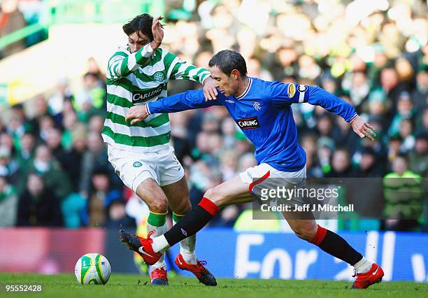 Georgios Samaras of Celtic tackles David Weir of Rangers during the Scottish Premier League match between Celtic and Rangers at Celtic Park on...