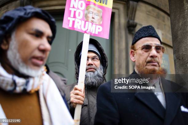 Demonstrator holds a No To Trump placard on Portland Place in freezing conditions ahead of a march against racism to mark the annual International...
