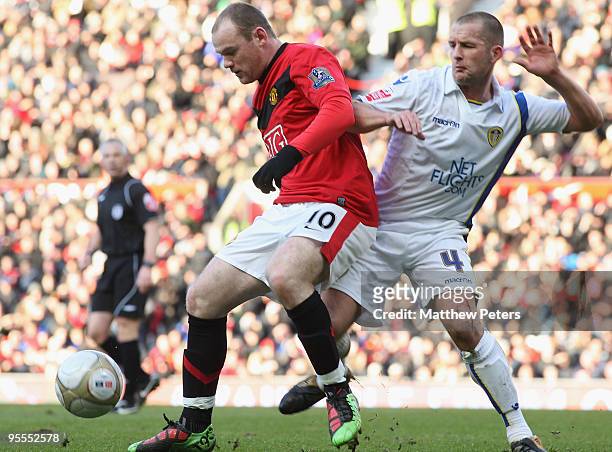 Wayne Rooney of Manchester United clashes with Michael Doyle of Leeds United during the FA Cup Sponsored by E.On Third Round match between Manchester...