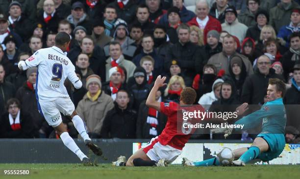 Tomasz Kuszczak and Wes Brown of Manchester United are unable to stop Jermaine Beckford of Leeds United scoring the opening goal during the FA Cup...