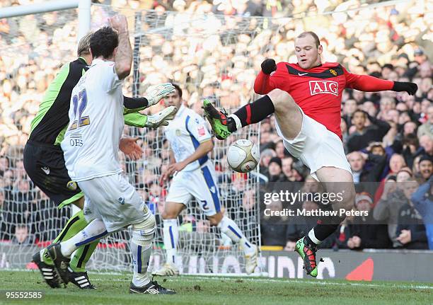 Wayne Rooney of Manchester United clashes with Casper Ankergren and Andy Hughes of Leeds United during the FA Cup Sponsored by E.On Third Round match...