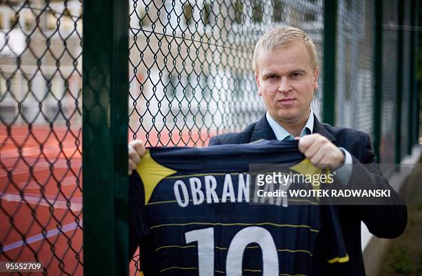Main coordinator-chief scout of the Polish Football Association's 'Scouting and Monitoring Polish Youth Abroad Section' Maciej Chorazyk poses holding...