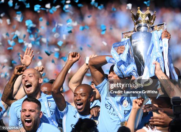 Vincent Kompany of Manchester City lifts the Premier League Trophy alongside David Silva, Nicolas Otamendi and Fernandinho as Manchester City...