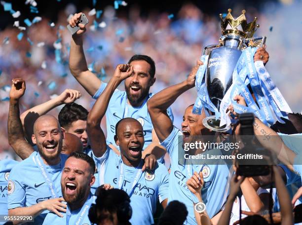 Vincent Kompany of Manchester City lifts the Premier League Trophy alongside David Silva, Nicolas Otamendi and Fernandinho as Manchester City...