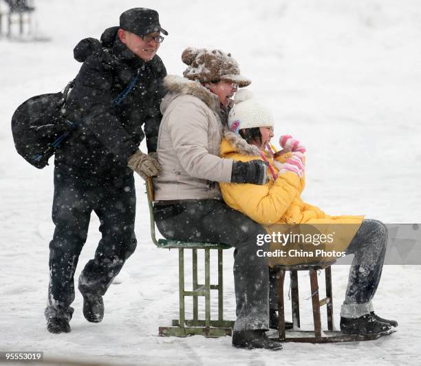 Residents play in snow at the Shichahai Lake area on January 3, 2010 in Beijing, China. The biggest snowfall in nearly 60 years blanketed Beijing...