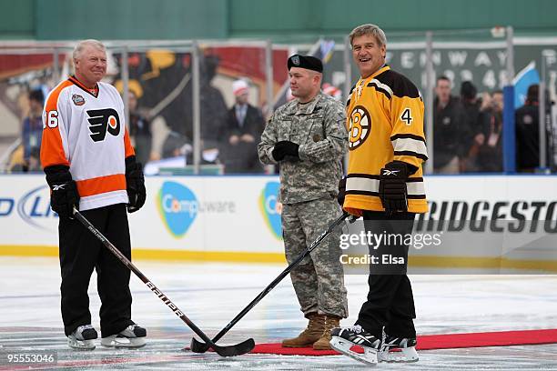 Staff Sergeant Ryan R. LaFrance prepares to drop the ceremonial first puck for Bobby Clarke honorary captain of the Philadelphia Flyers and Bobby Orr...