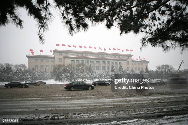 Cars run on the Chang'an Avenue in snow on January 3, 2010 in Beijing, China. The biggest snowfall in nearly 60 years blanketed Beijing today, as...