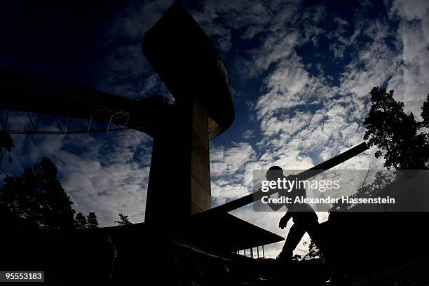 Martin Cikl of Czech Republic walks up to the jumping hill for the final round of the FIS Ski Jumping World Cup event of the 58th Four Hills ski...