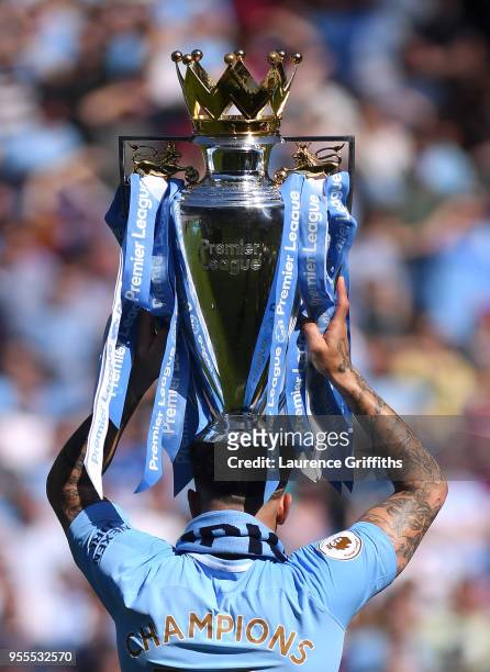 Kyle Walker of Manchester City holds the Premier League Trophy aloft as Manchester City celebrate winning the Premier League Title during the Premier...