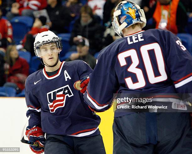 Jordan Schroeder of celebrates a first period goal with team mate Mike Lee of Team USA during the 2010 IIHF World Junior Championship Tournament game...