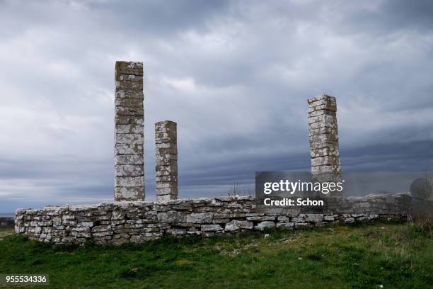 pillar from the gallowsback in visby against dark skies - visby stock pictures, royalty-free photos & images