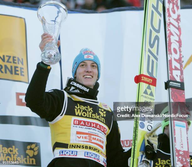 Gregor Schlierenzauer of Austria celebrates on the podium after winning the FIS Ski Jumping World Cup event of the 58th Four Hills ski jumping...