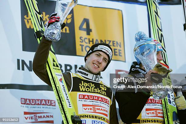 Simon Ammann of Switzerland celebrates on the podium after taking second place in the FIS Ski Jumping World Cup event of the 58th Four Hills ski...