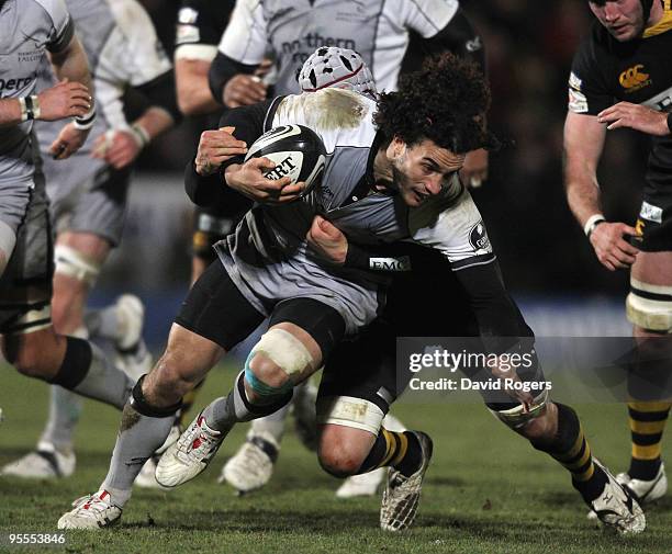 Tane Tu'ipulotu of Newcastle is held by Dan Ward-Smith of Wasps during the Guinness Premiership match between London Wasps and Newcastle Falcons at...