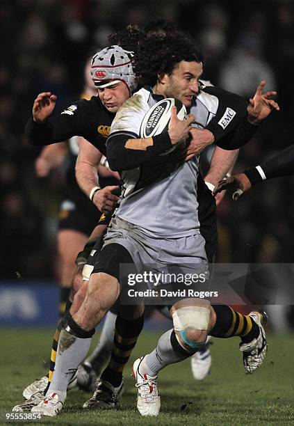 Tane Tu'ipulotu of Newcastle is held by Dan Ward-Smith of Wasps during the Guinness Premiership match between London Wasps and Newcastle Falcons at...