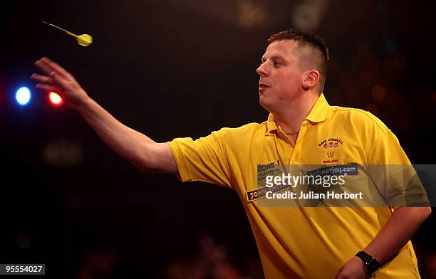 Dave Chisnall of England in action against Darryl Fitton of England during the World Professional Darts Championship 1st Round Match played at The...