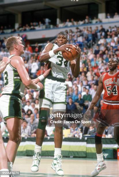 Greg Anderson of the Milwaukee Bucks grabs a rebound against the Chicago Bulls during an NBA basketball game circa 1990 at the Bradley Center in...