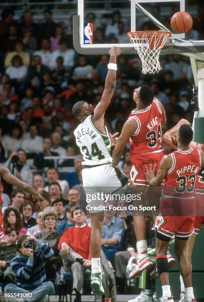 Greg Anderson of the Milwaukee Bucks shoots over Stacey King of the Chicago Bulls during an NBA basketball game circa 1990 at the Bradley Center in...