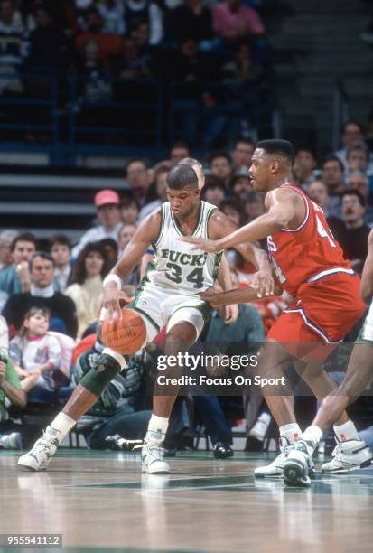 Greg Anderson of the Milwaukee Bucks backs in on Rick Mahorn of the Philadelphia 76ers during an NBA basketball game circa 1990 at the Bradley Center...