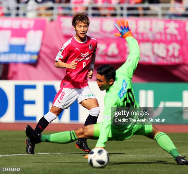 Yoichiro Kakitani of Cerezo Osaka scores the opening goal past Kenta Tokushige of V-Varen Nagasaki during the J.League J1 match between Cerezo Osaka...