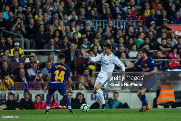 Cristiano Ronaldo from Portugal of Real Madrid defended by 14 Phillip Couthino from Brasil of FC Barcelona and 20 Sergi Roberto from Spain of FC...
