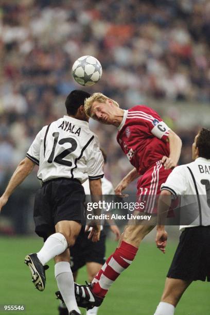 Bayern Munich captain Stefan Effenberg and Valencia's Fabian Ayala jump for the ball during the Uefa Champions League Final between Bayern Munich and...