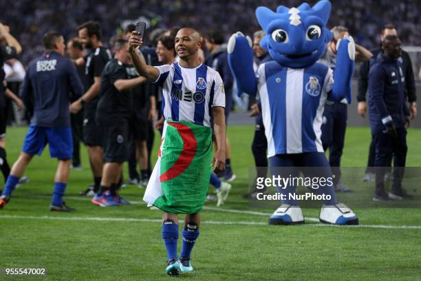 Porto's Algerian forward Yacine Brahimi celebrates the title of national champion during the Premier League 2017/18 match between FC Porto and CD...