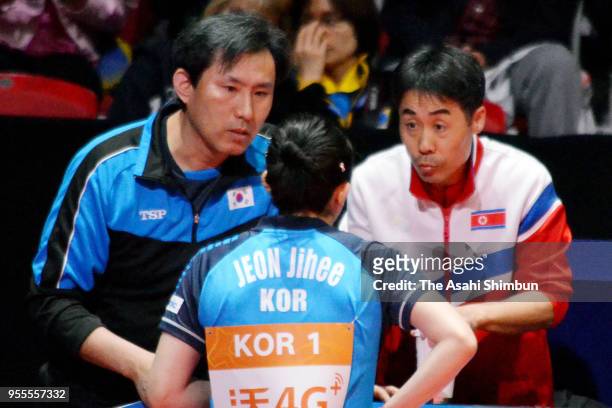 Jeon Jihee of Corea is advised by both South and North Korean coaches in the game against Mima Ito of Japan in the Women's semi final against Japan...