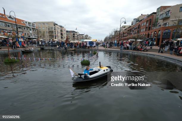 Boy rides a boat during a celebration of the Koningsdag or the King's day April 27 in Katwijk, Netherlands. King's day is a national holiday,...