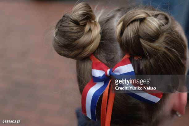 Dutch girl with a hair-do with a ribbon with national colors of the Netherlands attends a celebration of the Koningsdag or the King's day April 27 in...